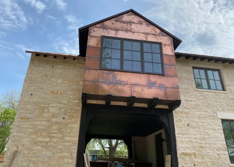 Copper metal panel facade on a stone building for Metal Roof Coating in Altus